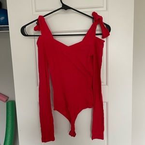 Candy apple red off shoulder long sleeve bodysuit with ties at shoulders.